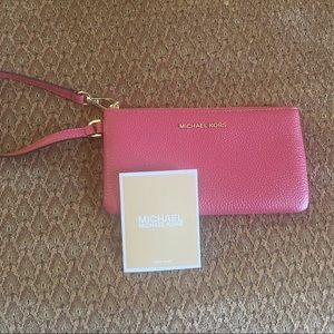 Cute pink Michael Kors wristlet, never used.
